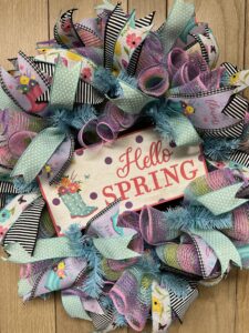 picture of deco mesh wreath with colorful spring ribbons and hello spring sign