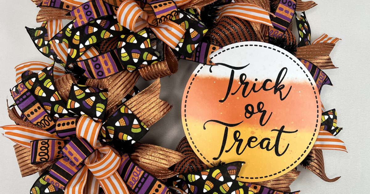 halloween wreath with orange and white ribbons, candy corn ribbons, purple and orange ribbons with matching sign and bows