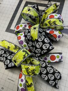 halloween bow made from halloween ribbons to attach to your wreath in our fall wreath making guide