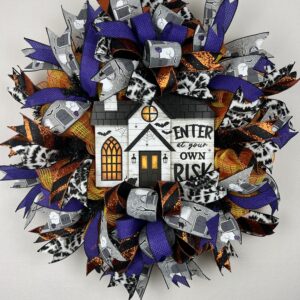 Halloween wreath, halloween wreath with sign saying enter at your own risk, halloween wreath with purple orange and black ribbons, two bows made with the sanme ribbons adorn this wreath