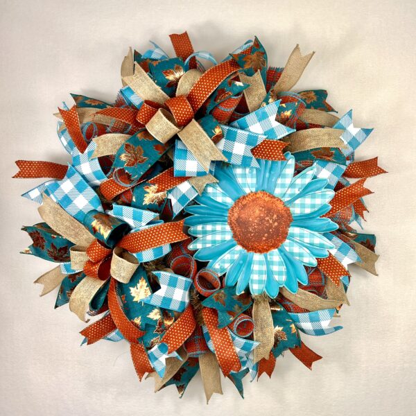 Sunflower fall wreath with teal sunflower sign, rus, gold, bronze and teal plaid ribbons adorn thewreath, matching ribbon bows adorn this wreath, on a base of rust and teal deco mesh