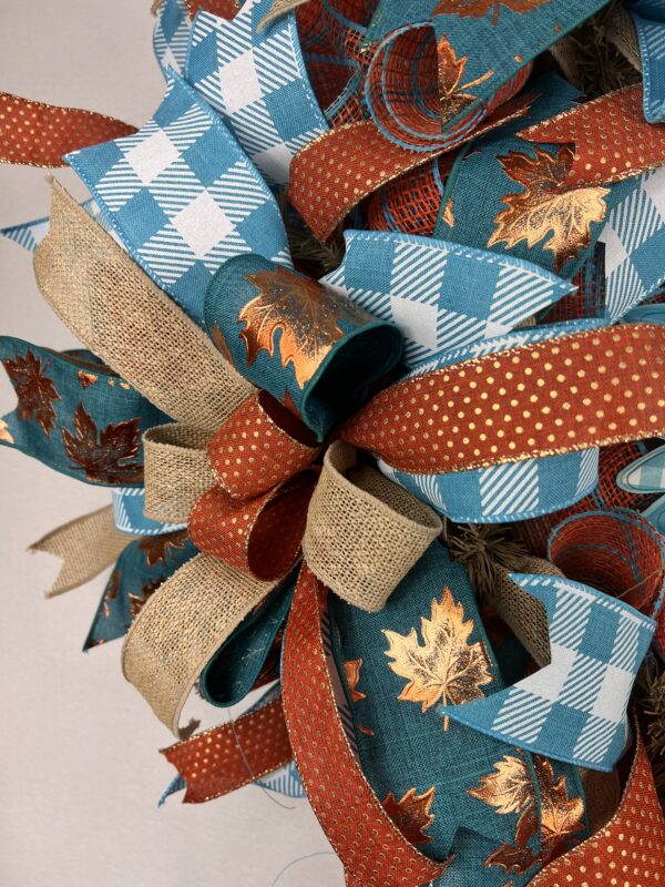 Sunflower fall wreath with teal sunflower sign, rus, gold, bronze and teal plaid ribbons adorn thewreath, matching ribbon bows adorn this wreath, on a base of rust and teal deco mesh