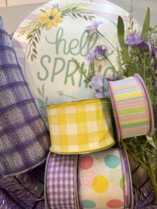 hello spring deco mesh wreath supplies, spring ribbons of pastel stripes, pastel polka dots, yellow and white check ribbon, purple and white ribbon, lavender flower spray, lavender and white check deco mesh, lavender wreath form