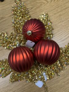 gold glitter fern sprays and red matte bulb ornaments for a deco mesh wreath