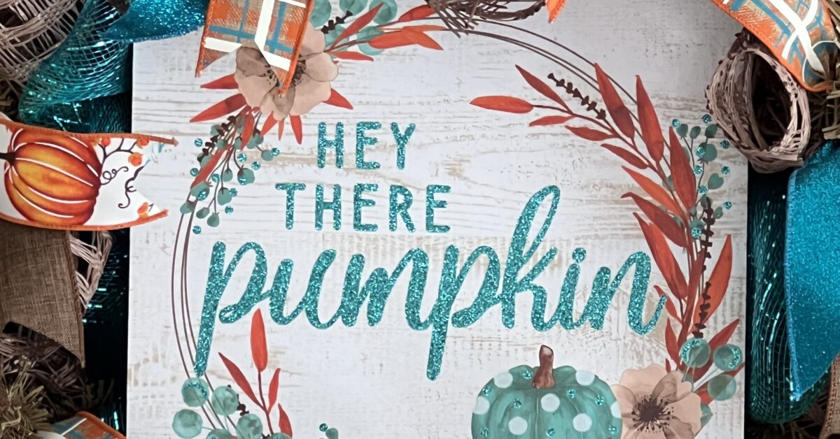 fall wreath with Hey there Pumkin sign, teal and brown plaid ribbon, pumpkin ribbons, brown and teal deco mesh base, matching bow