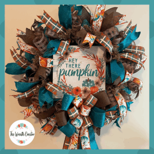 Fall wreath,Featuring a playful pumpkin-themed sign, shimmering teal ribbons, rustic brown mesh, and plaid accents, this wreath is full of personality and charm