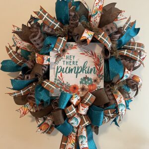 fall wreath with hey there pumpkin sign, pumpkin plaid and teal sprkly ribbons and big beautiful bow